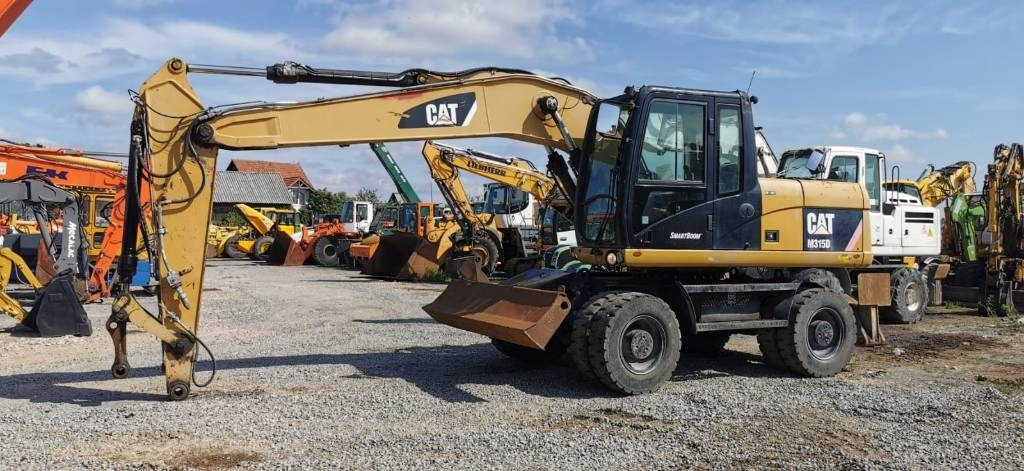 CAT M 315 D - 휠 굴삭기 : 사진 1 CAT M 315 D - 휠 굴삭기 : 사진 1